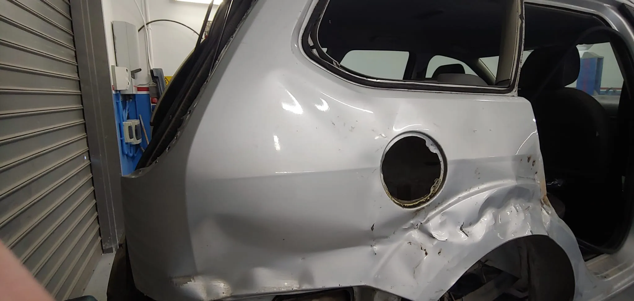 Ford Focus, danno da incidente sulla fiancata posteriore con lamiera accartocciata