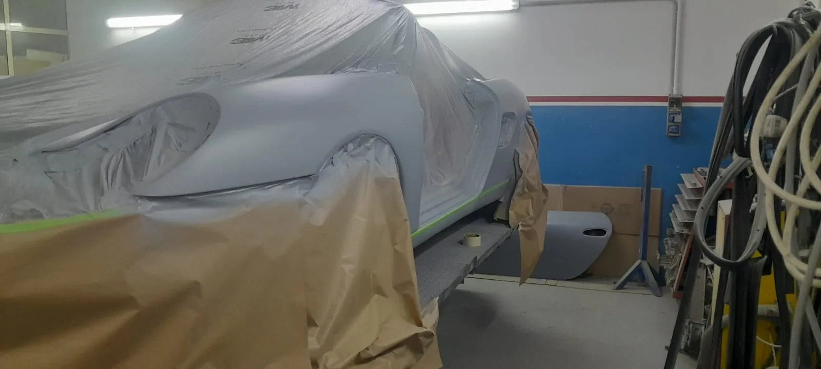 Porsche Boxster in cabina di verniciatura, vista frontale tre quarti